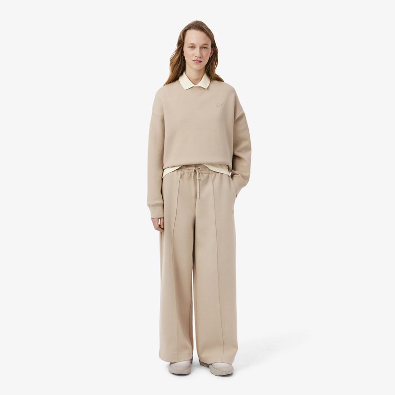 Женские хлопковые спортивные брюки-клёш Lacoste